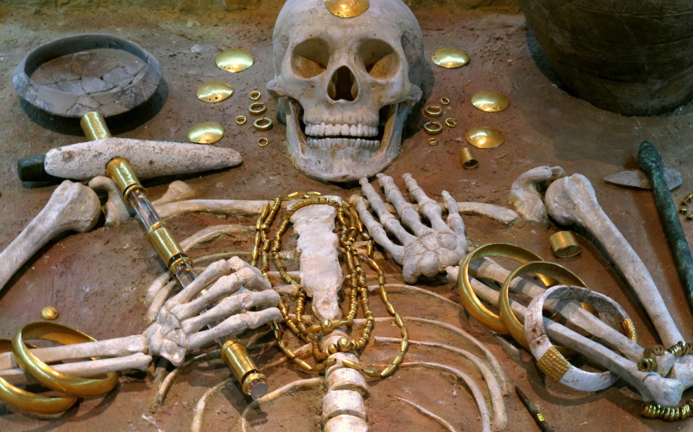 A skeleton surrounded by gold coins